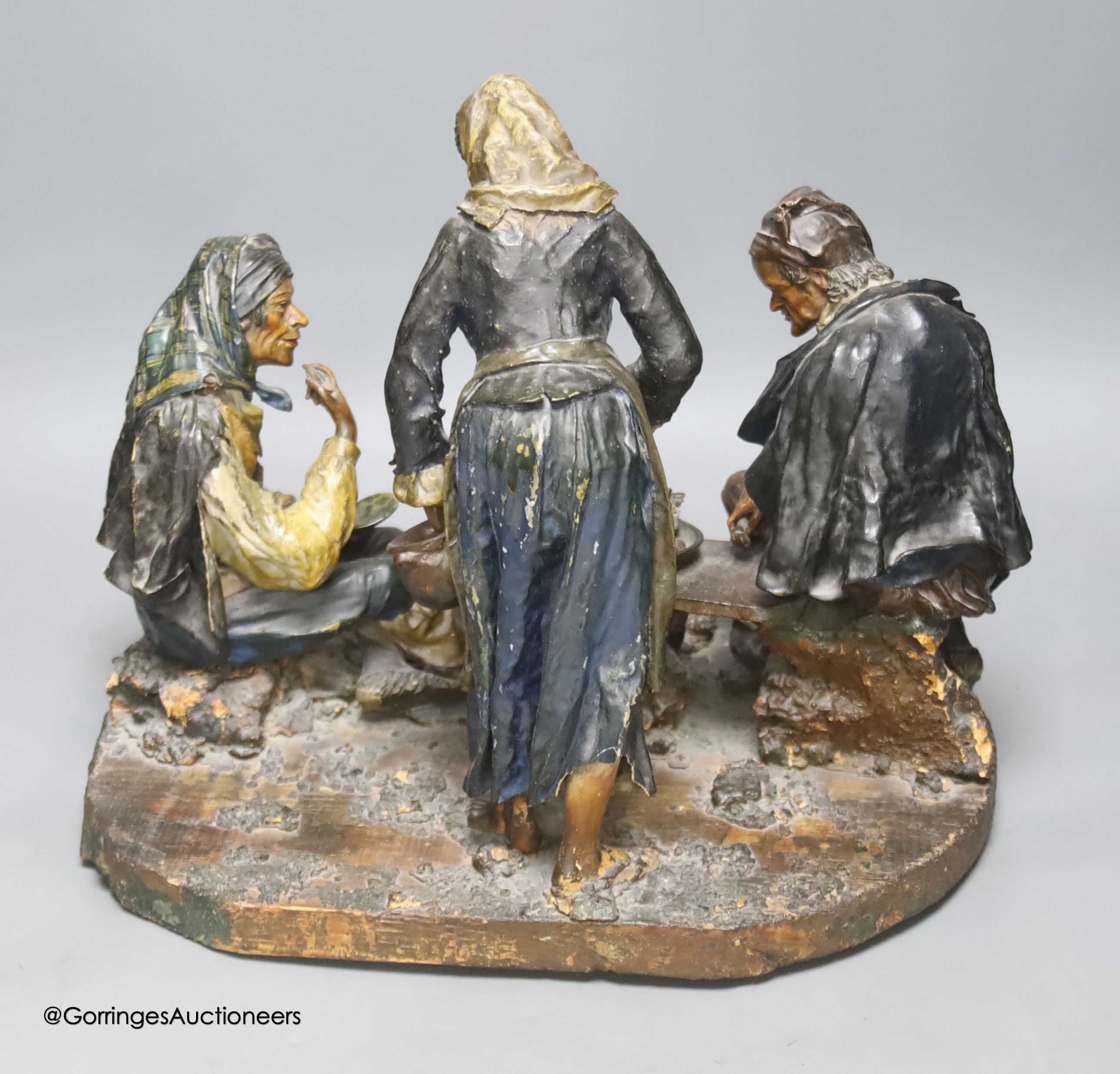 A continental worked leather figure group of two gentleman and a lady, width 87cm